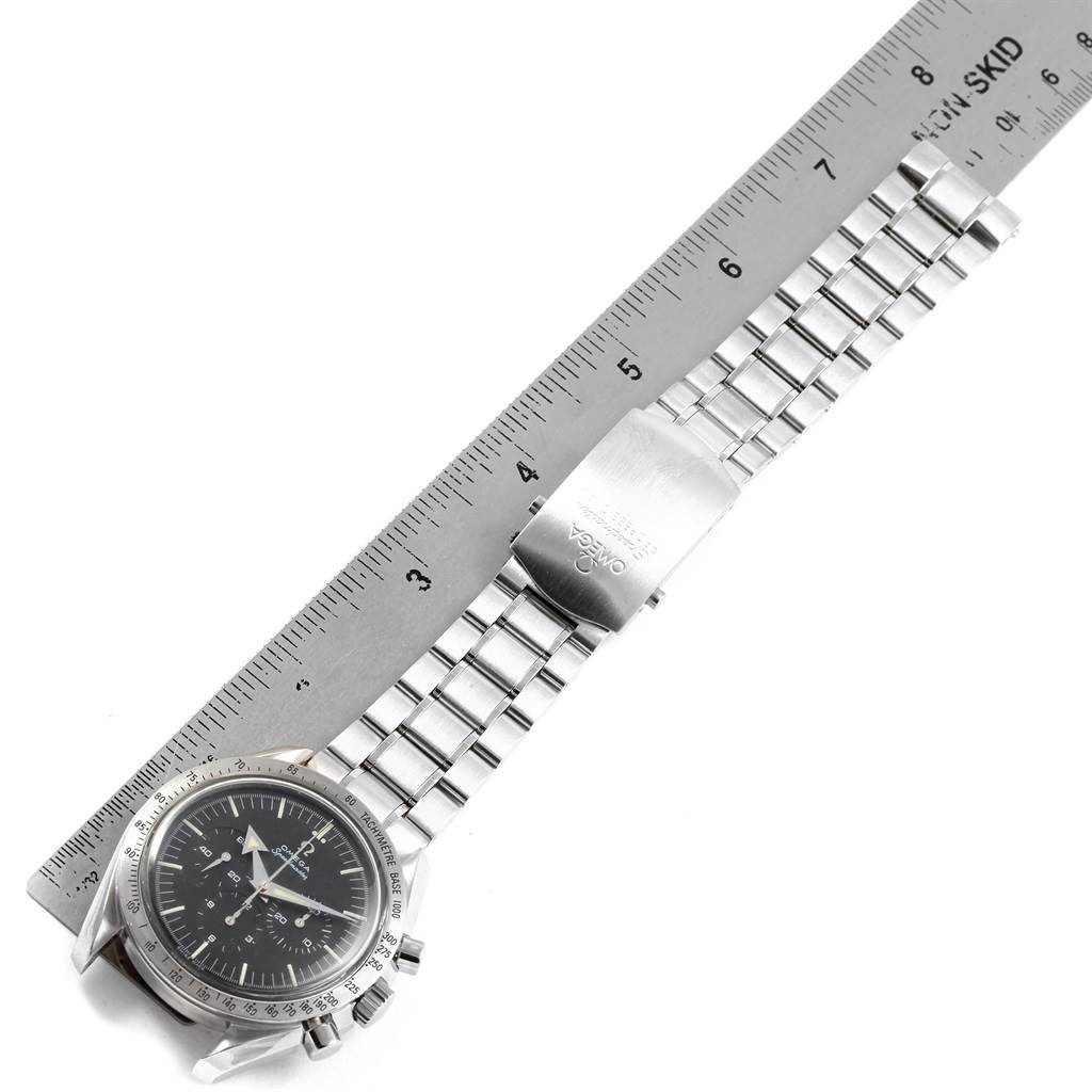 The image shows an Omega Speedmaster 3594.50.00 Men
s Stainless Steel Black Dial 3594.50.00 Men
s Stainless Steel Black Dial watch with a metal bracelet laid out next to a ruler.