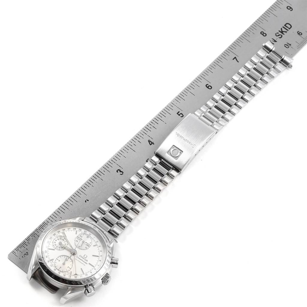 The image shows an Omega Speedmaster 3521.30.00 Men
s Stainless Steel Silver Dial 3521.30.00 Men
s Stainless Steel Silver Dial watch at a top-down angle, featuring the watch face, bracelet, and clasp, with a ruler alongside.