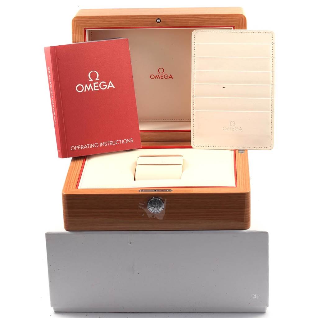 This image shows the packaging and accessories for an Omega Speedmaster 327.10.43.50.06.001 Men
s Stainless Steel Grey Dial 327.10.43.50.06.001 Men
s Stainless Steel Grey Dial, including the wooden box, operating manual, and cardholder.