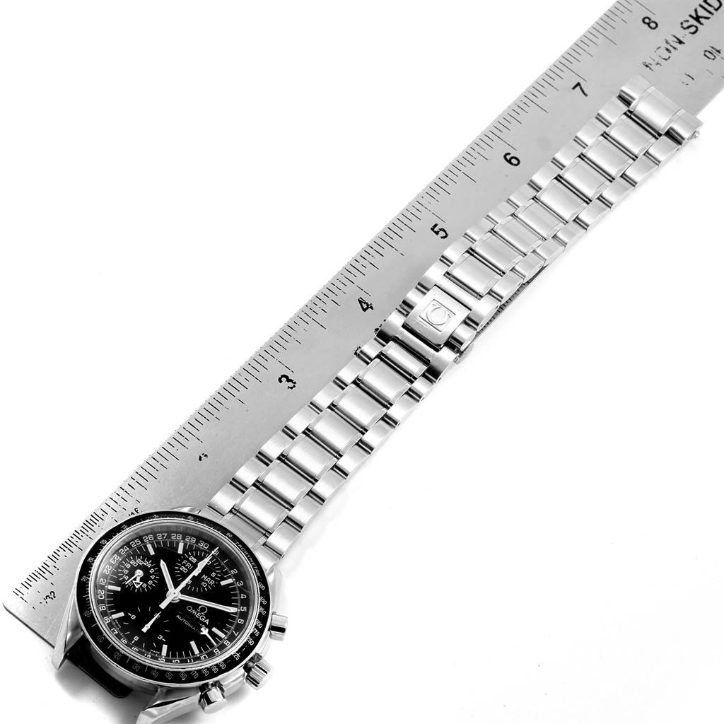 The image shows an Omega Speedmaster 3520.50.00 Men
s Stainless Steel Black Dial 3520.50.00 Men
s Stainless Steel Black Dial watch laid flat with its stainless steel bracelet next to a ruler for measurement.