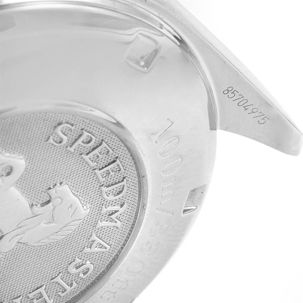 This is an angled close-up view of the back of an Omega Speedmaster 3210.51.00 Men
s Stainless Steel Black Dial 3210.51.00 Men
s Stainless Steel Black Dial watch, showing the engraved logo and serial number.