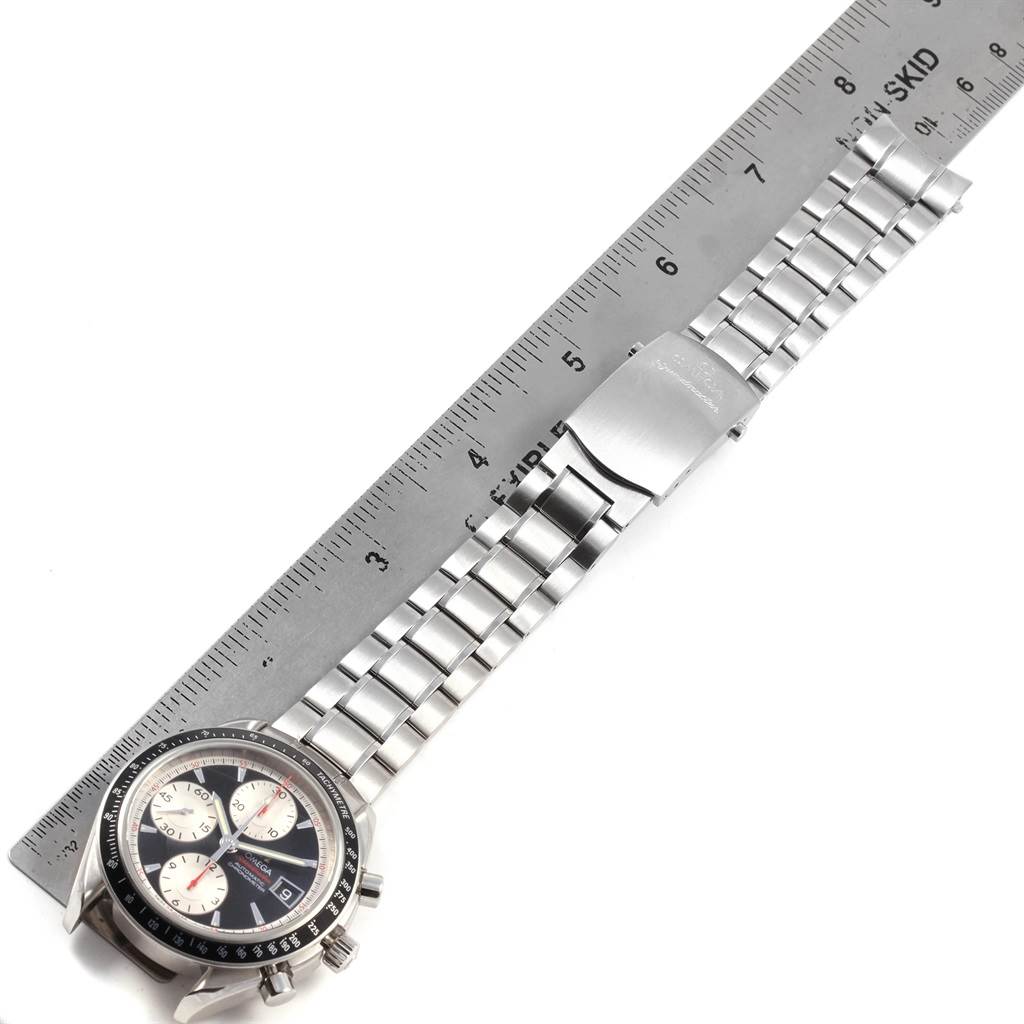 The image shows the Omega Speedmaster 3210.51.00 Men
s Stainless Steel Black Dial 3210.51.00 Men
s Stainless Steel Black Dial watch at an oblique angle, highlighting the dial and metal bracelet alongside a ruler for scale.