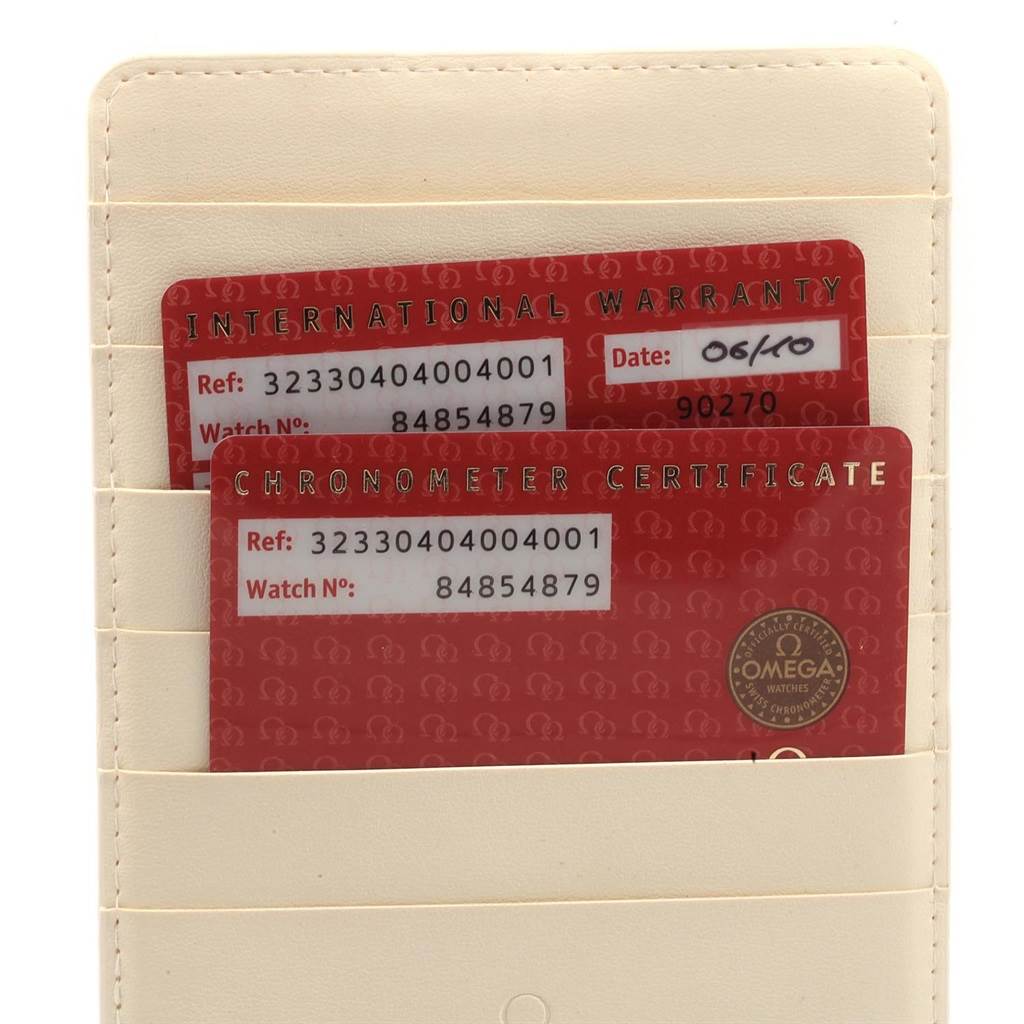 The image shows the International Warranty and Chronometer Certificate cards for an Omega Speedmaster 323.30.40.40.04.001 Men
s Stainless Steel White Dial 323.30.40.40.04.001 Men
s Stainless Steel White Dial watch, displayed in a cardholder.