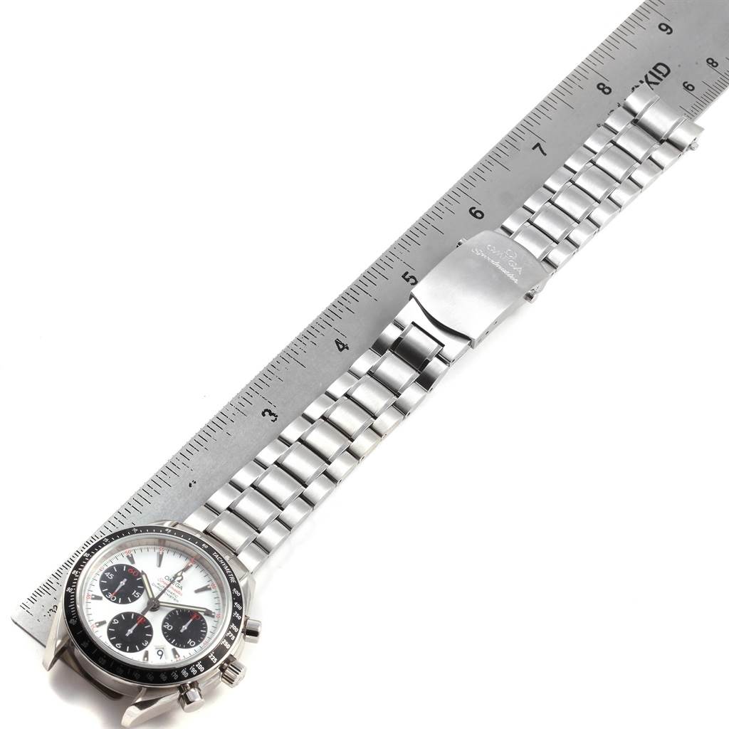 The image shows an Omega Speedmaster 323.30.40.40.04.001 Men
s Stainless Steel White Dial 323.30.40.40.04.001 Men
s Stainless Steel White Dial watch with a metal bracelet, horizontal, next to a ruler.