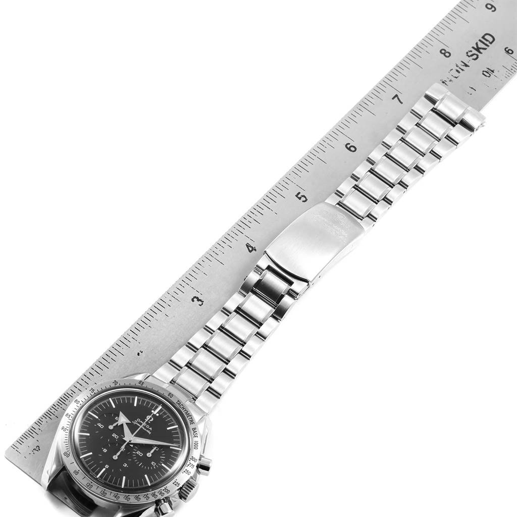 The image shows the Omega Speedmaster 3594.50.00 Men
s Stainless Steel Black Dial 3594.50.00 Men
s Stainless Steel Black Dial watch, its stainless steel bracelet, and clasp, measured against a ruler.