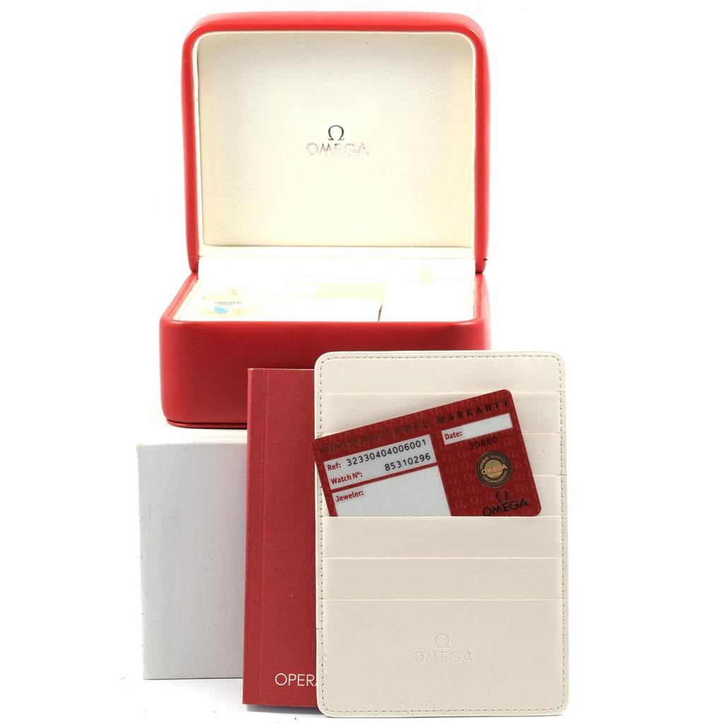 The image shows the Omega Speedmaster 323.30.40.40.06.001 Men
s Stainless Steel Grey Dial 323.30.40.40.06.001 Men
s Stainless Steel Grey Dial watch
s storage box, warranty card, and manual from a front angle.