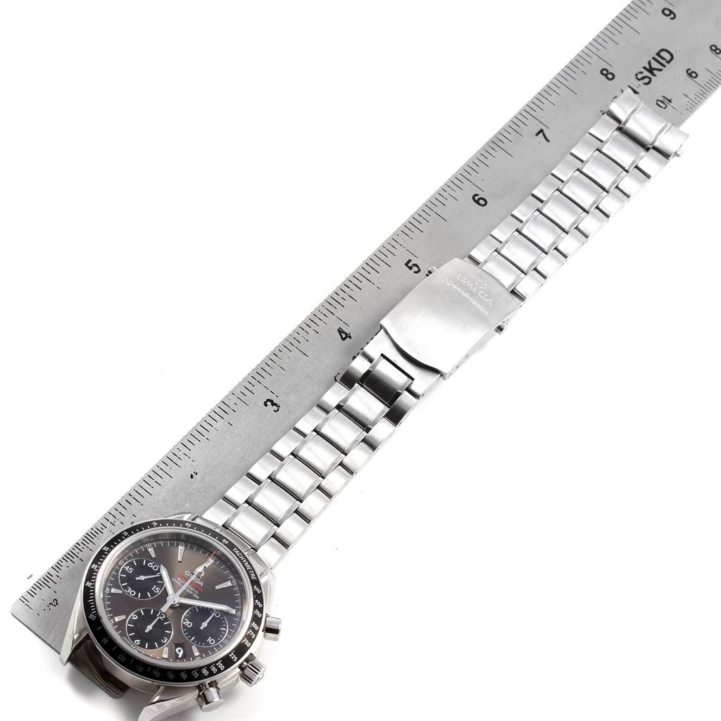 The Omega Speedmaster 323.30.40.40.06.001 Men
s Stainless Steel Grey Dial 323.30.40.40.06.001 Men
s Stainless Steel Grey Dial watch is shown from the top, displaying the dial, case, and metal bracelet next to a ruler.