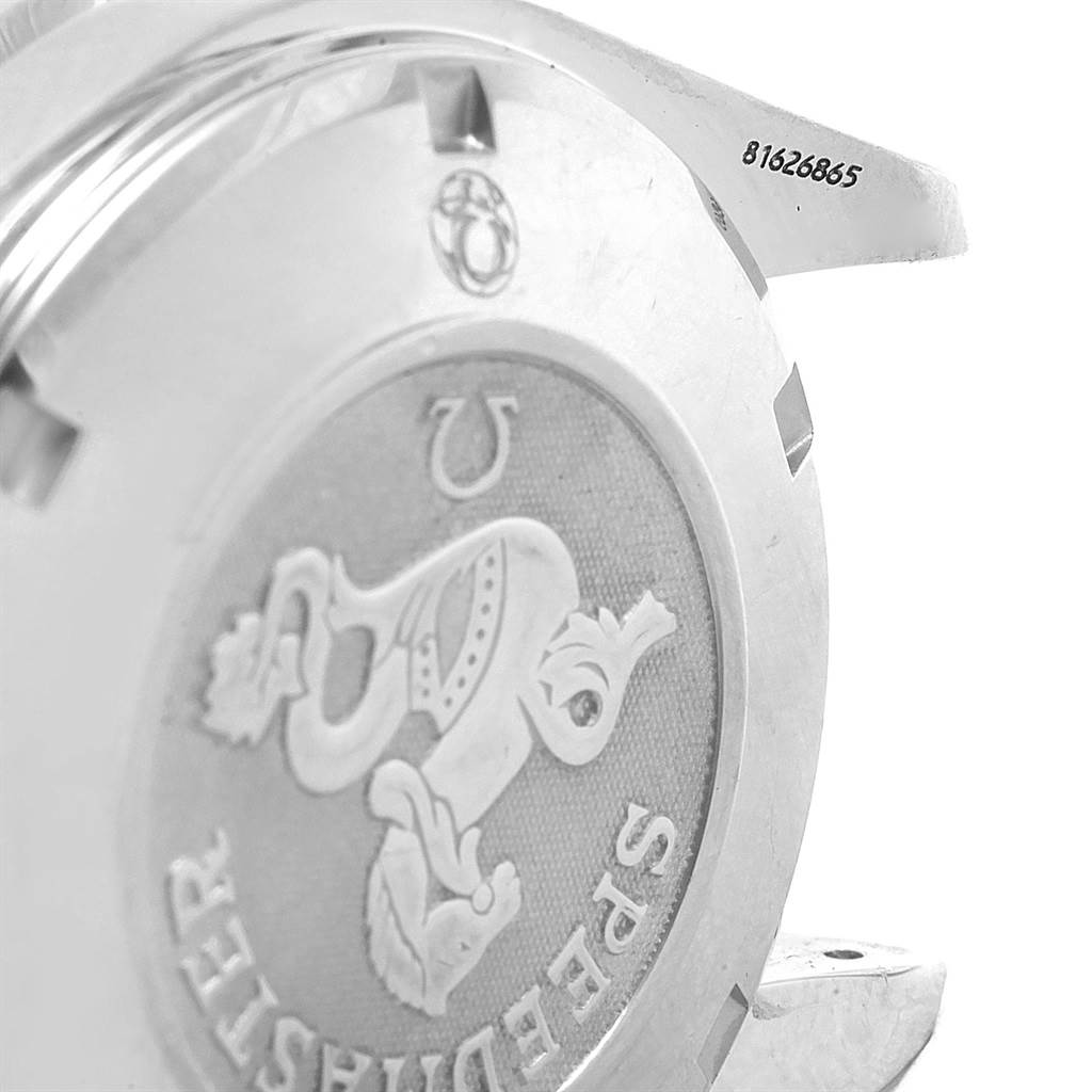 The image shows the back case of an Omega Speedmaster 3212.80.00 Men
s Stainless Steel Blue Dial 3212.80.00 Men
s Stainless Steel Blue Dial watch at an angle, highlighting its embossed logo and serial number.