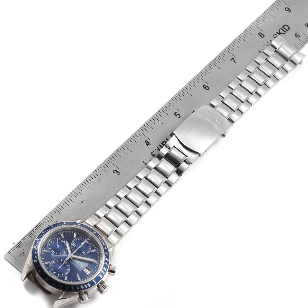 The image shows an Omega Speedmaster 3212.80.00 Men
s Stainless Steel Blue Dial 3212.80.00 Men
s Stainless Steel Blue Dial watch lying flat with its face and bracelet fully visible alongside a ruler for scale.
