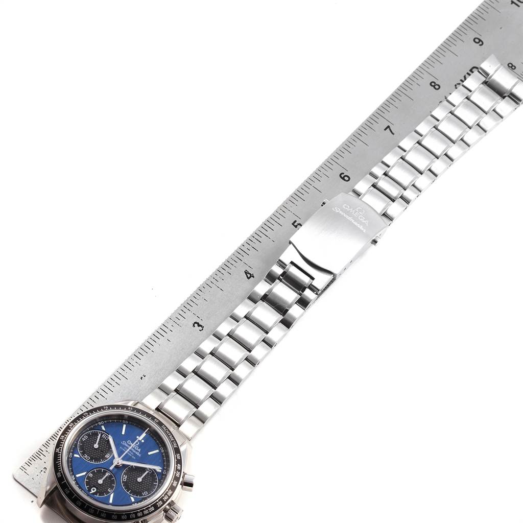 The image shows an Omega Speedmaster 326.30.40.50.03.001 Men
s Stainless Steel Blue Dial 326.30.40.50.03.001 Men
s Stainless Steel Blue Dial watch laid flat with the face, stainless steel bracelet, and clasp visible next to a ruler.