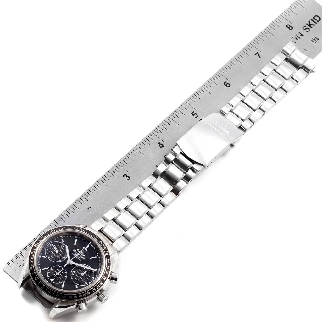 The image shows an Omega Speedmaster 326.30.40.50.01.001 Men
s Stainless Steel Black Dial 326.30.40.50.01.001 Men
s Stainless Steel Black Dial watch laid flat against a ruler, displaying the watch face and metal band.