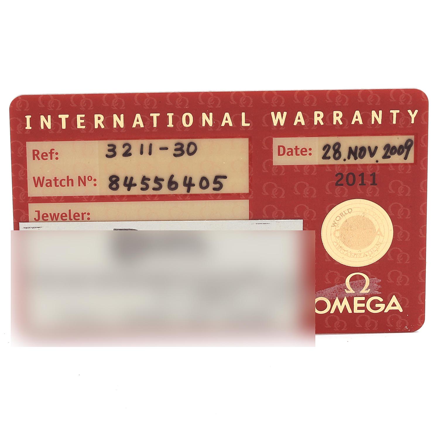 An international warranty card for the Omega Speedmaster 3211.30.00 Men's Stainless Steel Silver Dial 3211.30.00 Men's Stainless Steel Silver Dial watch, showing reference number, watch number, and purchase date.