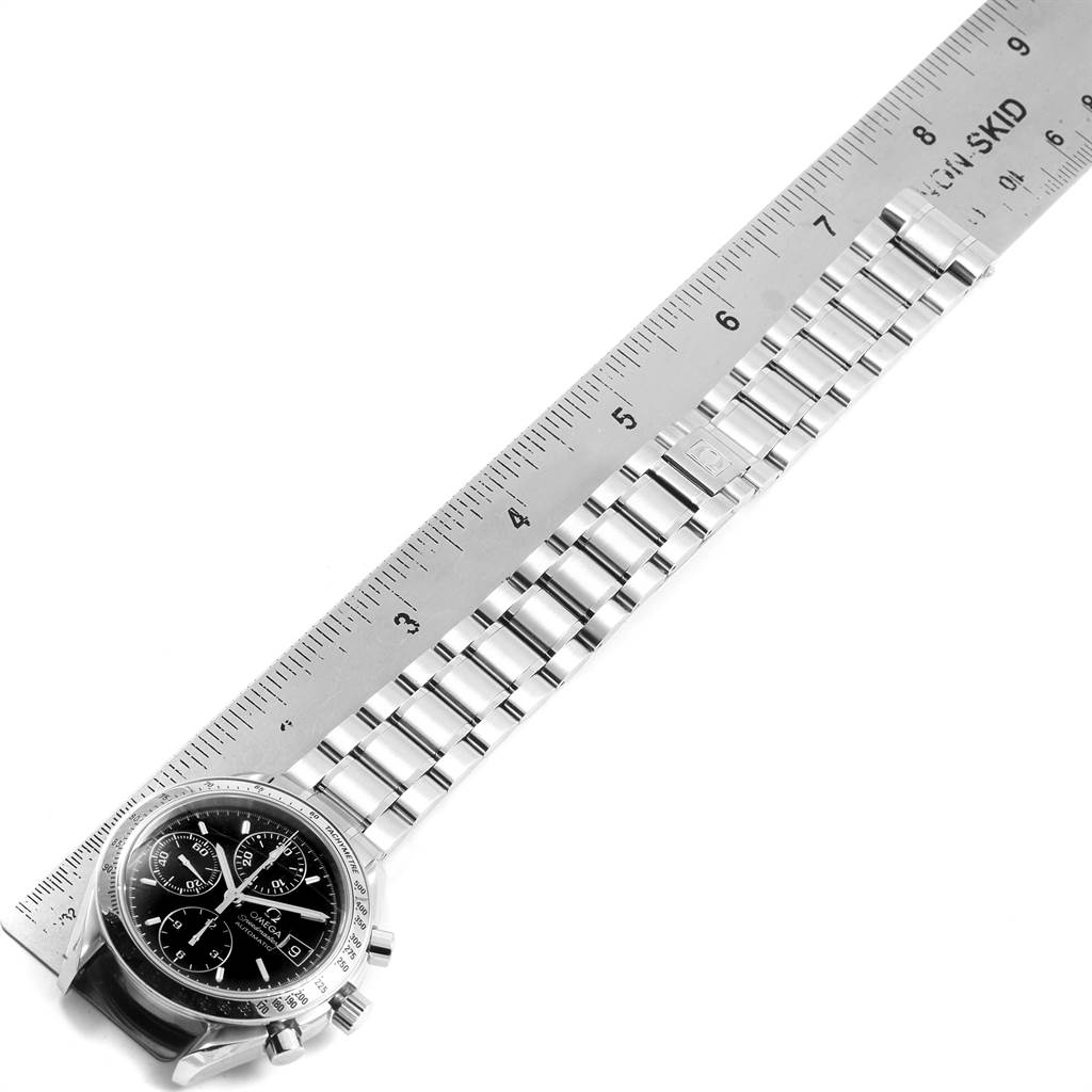 The image shows an Omega Speedmaster 3513.50.00 Men
s Stainless Steel Black Dial 3513.50.00 Men
s Stainless Steel Black Dial watch laid out flat next to a ruler, displaying the face and metal band.