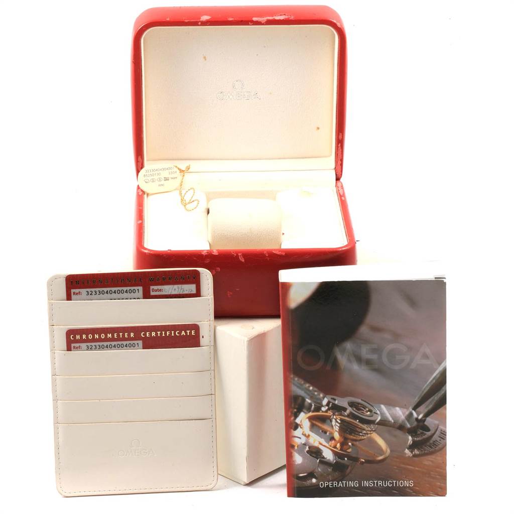 The image shows an Omega Speedmaster 323.30.40.40.04.001 Men
s Stainless Steel White Dial 323.30.40.40.04.001 Men
s Stainless Steel White Dial watch box, chronometer certificate, and operating instructions, taken from the front.