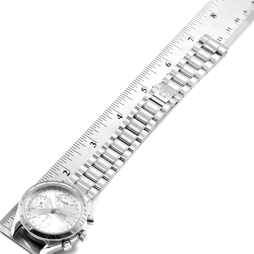 The image shows an Omega Speedmaster 3523.30.00 Men's Stainless Steel Silver Dial 3523.30.00 Men's Stainless Steel Silver Dial watch laid flat next to a ruler, focusing on its stainless steel bracelet and partial view of the dial.