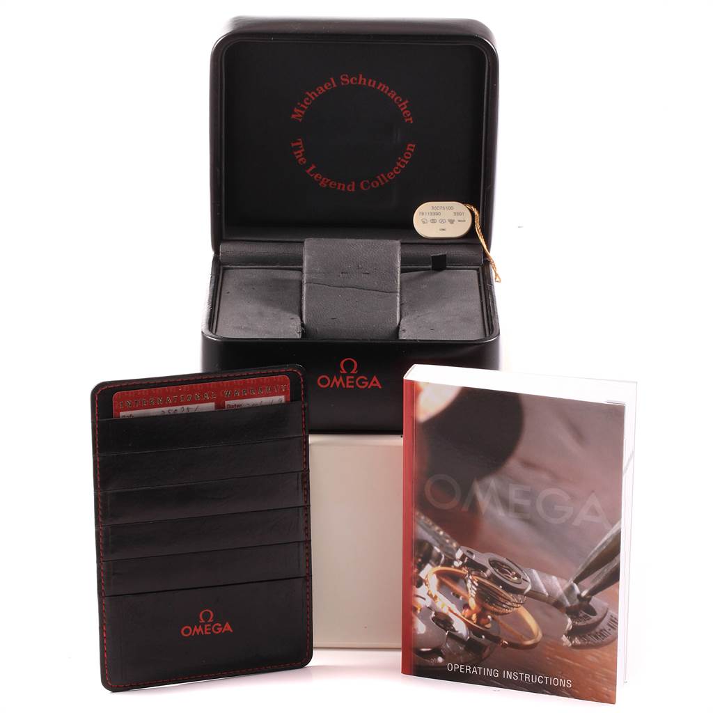 The image shows an Omega Speedmaster 3507.51.00 Men
s Stainless Steel Black Dial 3507.51.00 Men
s Stainless Steel Black Dial watch box, a warranty cardholder, and an operating instructions manual.