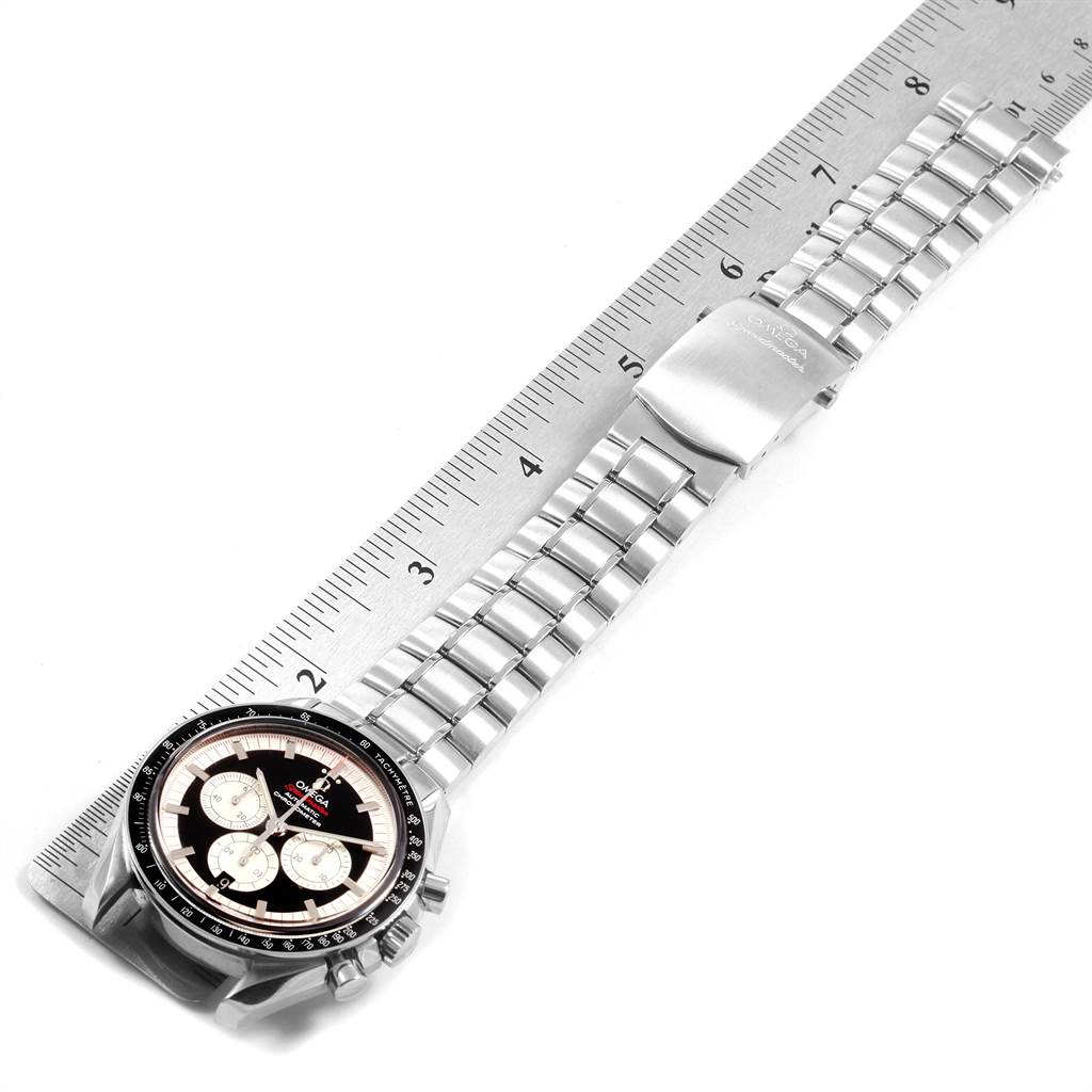 The image shows the face, bracelet, and clasp of the Omega Speedmaster 3507.51.00 Men
s Stainless Steel Black Dial 3507.51.00 Men
s Stainless Steel Black Dial watch laid parallel to a ruler.