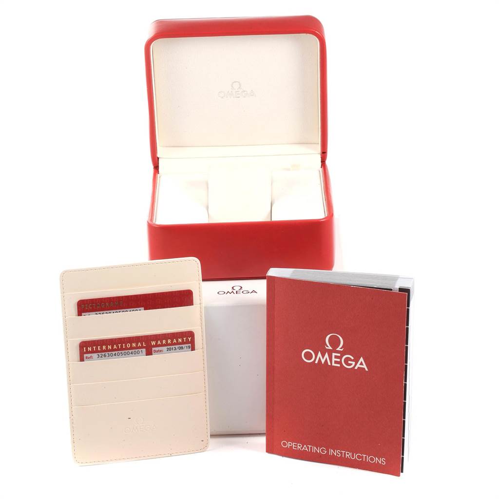 The image shows the accessories of an Omega Speedmaster 326.30.40.50.04.001 Men
s Stainless Steel White Dial 326.30.40.50.04.001 Men
s Stainless Steel White Dial, including a red box, warranty cards, and an operating instructions book.