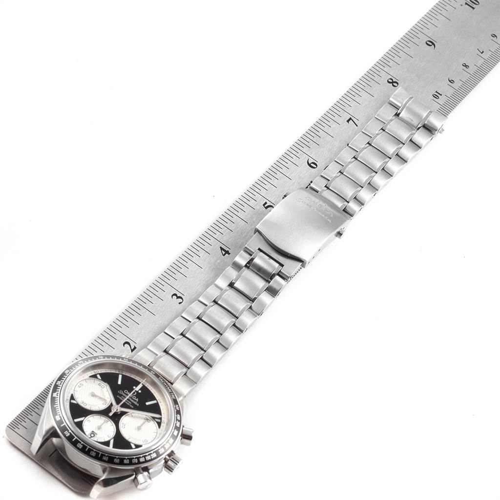 The image shows an Omega Speedmaster 326.30.40.50.01.002 Men
s Stainless Steel Black Dial 326.30.40.50.01.002 Men
s Stainless Steel Black Dial watch laid flat alongside a ruler, highlighting the watch face, bracelet, and clasp.