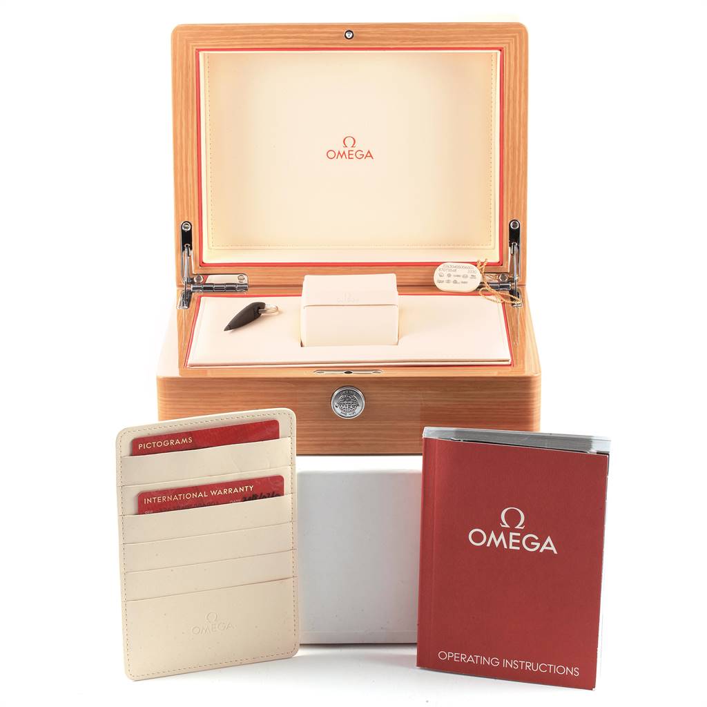 The image shows the packaging and accessories for the Omega Speedmaster 326.30.40.50.06.001 Men
s Stainless Steel Grey Dial 326.30.40.50.06.001 Men
s Stainless Steel Grey Dial, including the box, instruction manual, and warranty cards.