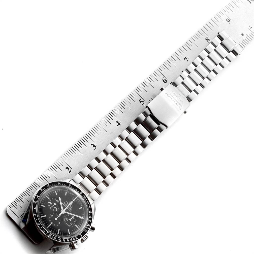 The image shows an Omega Speedmaster 3570.50.00 Men's Stainless Steel Black Dial 3570.50.00 Men's Stainless Steel Black Dial watch laid alongside a ruler, highlighting its face, bracelet, and clasp.