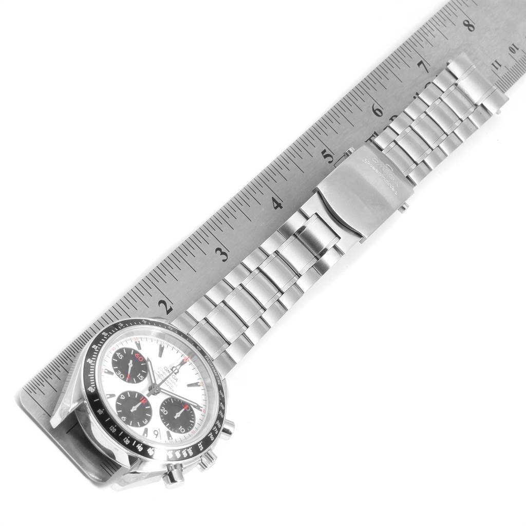 The image shows the Omega Speedmaster 323.30.40.40.04.001 Men
s Stainless Steel White Dial 323.30.40.40.04.001 Men
s Stainless Steel White Dial watch laid flat, emphasizing its stainless steel bracelet and clasp beside a ruler.