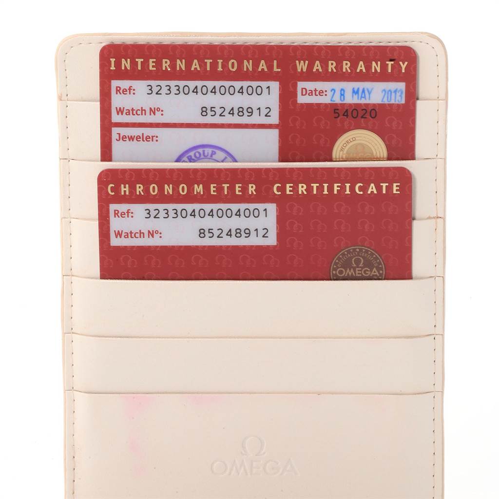 The image shows an Omega Speedmaster 323.30.40.40.04.001 Men
s Stainless Steel White Dial 323.30.40.40.04.001 Men
s Stainless Steel White Dial watch
s International Warranty and Chronometer Certificate cards in a cardholder.