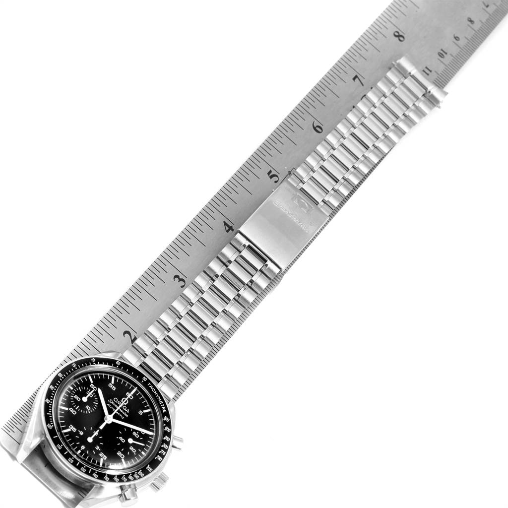 The image shows an Omega Speedmaster 3510.50.00 Men
s Stainless Steel Black Dial 3510.50.00 Men
s Stainless Steel Black Dial watch with a stainless steel bracelet, laid flat against a ruler.