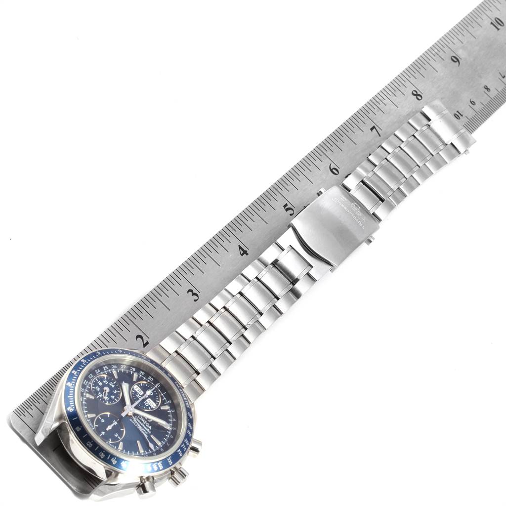 The image shows an Omega Speedmaster 3222.80.00 Men
s Stainless Steel Blue Dial 3222.80.00 Men
s Stainless Steel Blue Dial watch with a stainless steel bracelet, positioned next to a ruler for scale.