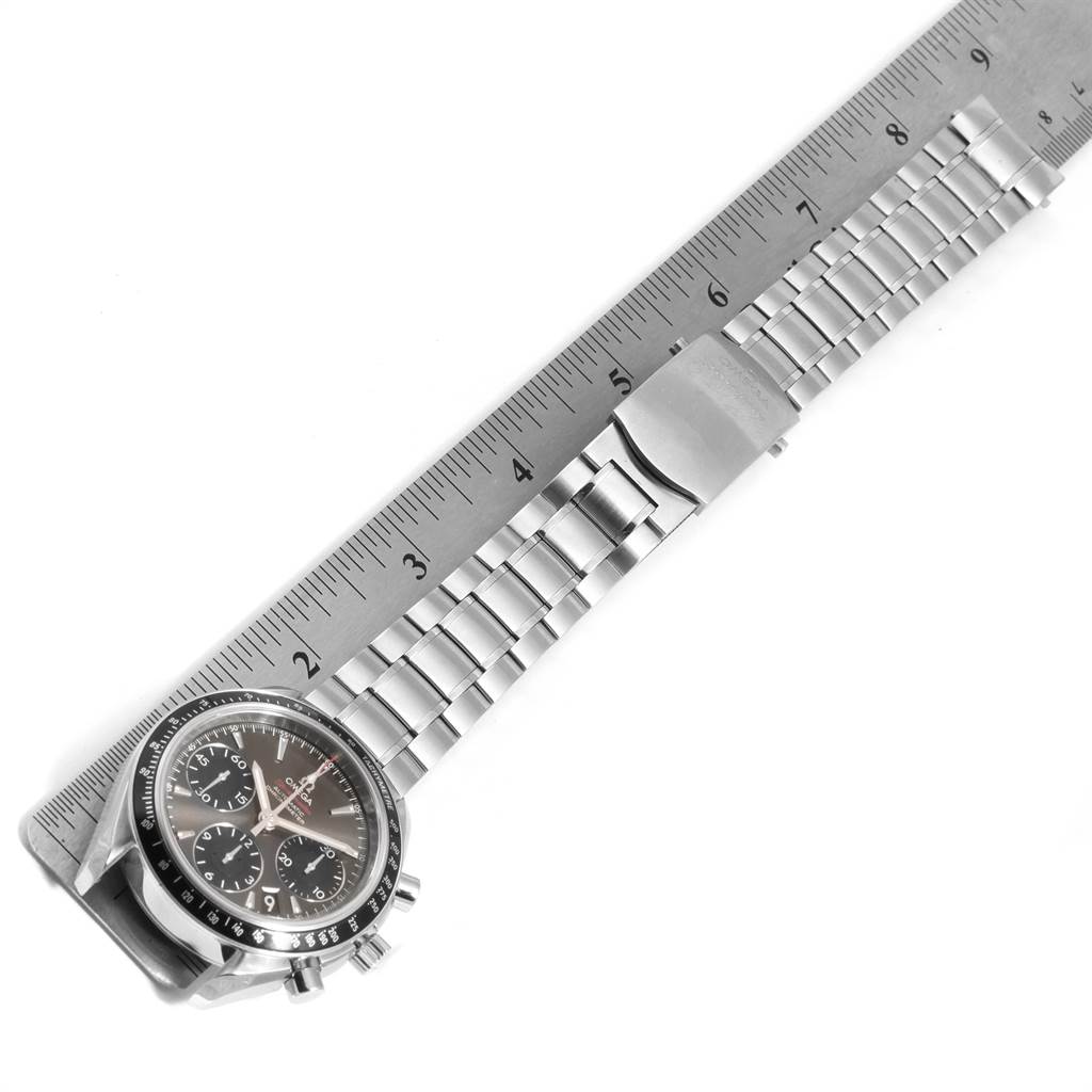 The image shows a top-down view of the Omega Speedmaster 323.30.40.40.06.001 Men
s Stainless Steel Grey Dial 323.30.40.40.06.001 Men
s Stainless Steel Grey Dial watch with its metal bracelet aligned next to a ruler for measurement.