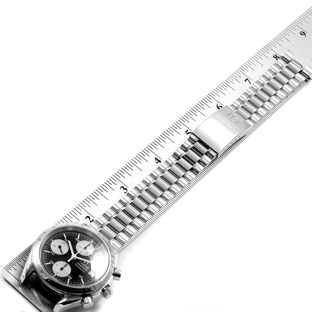 The image shows an Omega Speedmaster 3511.50.00 Men
s Stainless Steel Black Dial 3511.50.00 Men
s Stainless Steel Black Dial watch laid flat with its bracelet measured against a ruler.