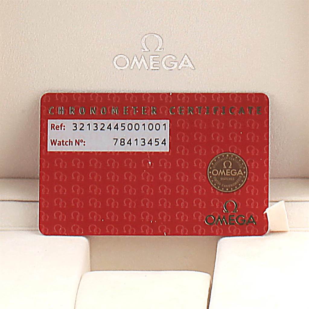 This image shows a red Omega Speedmaster 321.32.44.50.01.001 Men
s Stainless Steel Black Dial 321.32.44.50.01.001 Men
s Stainless Steel Black Dial Chronometer Certificate card with reference and watch numbers, positioned against a white background.