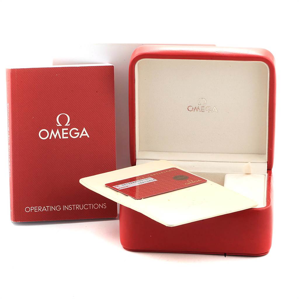 The image shows a red Omega Speedmaster 321.32.44.50.01.001 Men
s Stainless Steel Black Dial 321.32.44.50.01.001 Men
s Stainless Steel Black Dial watch box, operating instructions booklet, and warranty card holder.