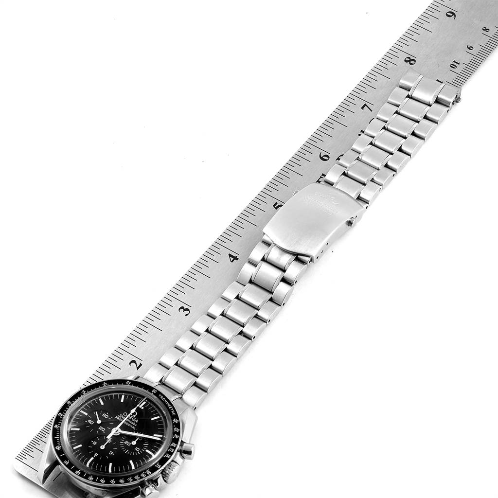 The image shows an Omega Speedmaster 3573.50.00 Men
s Stainless Steel Black Dial 3573.50.00 Men
s Stainless Steel Black Dial watch laid flat against a ruler, displaying the face, bracelet, and clasp.