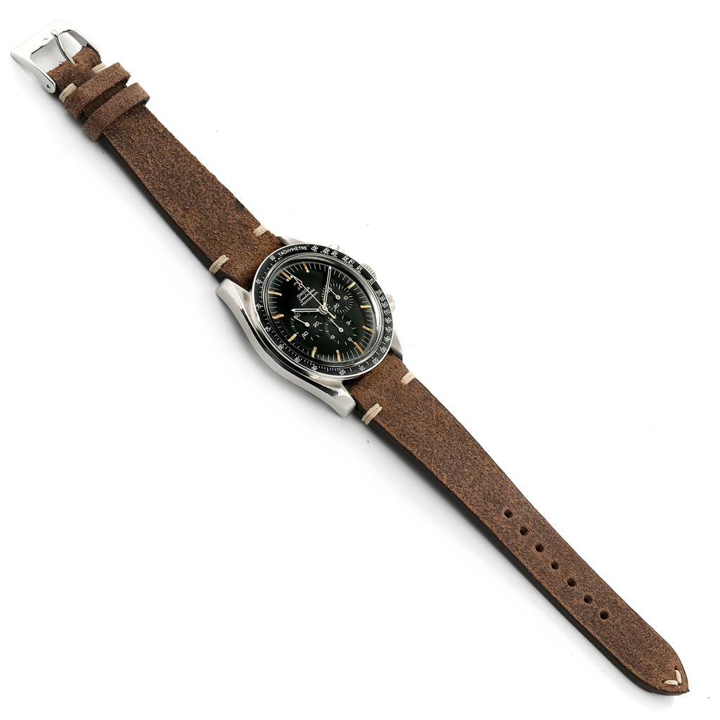 The Omega Speedmaster 145.012 Men's Stainless Steel Black Dial 145.012 Men's Stainless Steel Black Dial watch is shown from a top-down angle, highlighting its face, bezel, and brown leather strap.