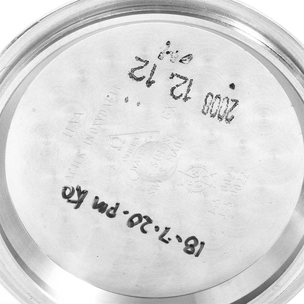 The image shows the interior of the case back of an Omega Speedmaster 3570.50.00 Men
s Stainless Steel Black Dial 3570.50.00 Men
s Stainless Steel Black Dial watch, featuring engraved markings and some hand-written notes.