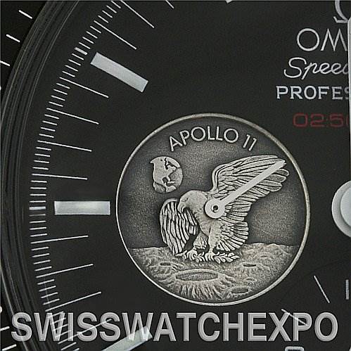 The image shows a close-up of the dial of the Omega Speedmaster 311.   30.   42.   30.   01.   002 Men
s Stainless Steel Black Dial 311.   30.   42.   30.   01.   002 Men
s Stainless Steel Black Dial, highlighting the Apollo 11 mission emblem.