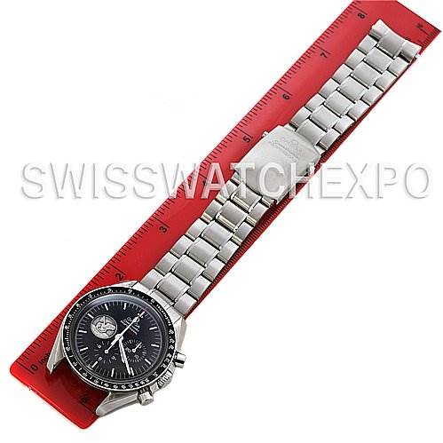 The Omega Speedmaster 311.   30.   42.   30.   01.   002 Men
s Stainless Steel Black Dial 311.   30.   42.   30.   01.   002 Men
s Stainless Steel Black Dial watch is laid flat on a red ruler, showing the entire face and stainless steel bracelet.