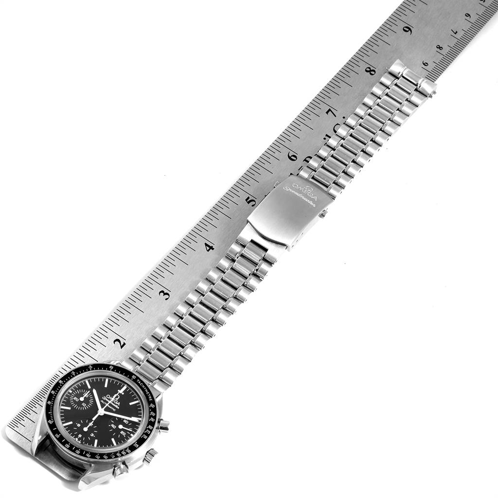 This image shows an Omega Speedmaster 3539.50.00 Men
s Stainless Steel Black Dial 3539.50.00 Men
s Stainless Steel Black Dial watch laying flat next to a ruler, displaying the face, bezel, pushers, and metal bracelet.