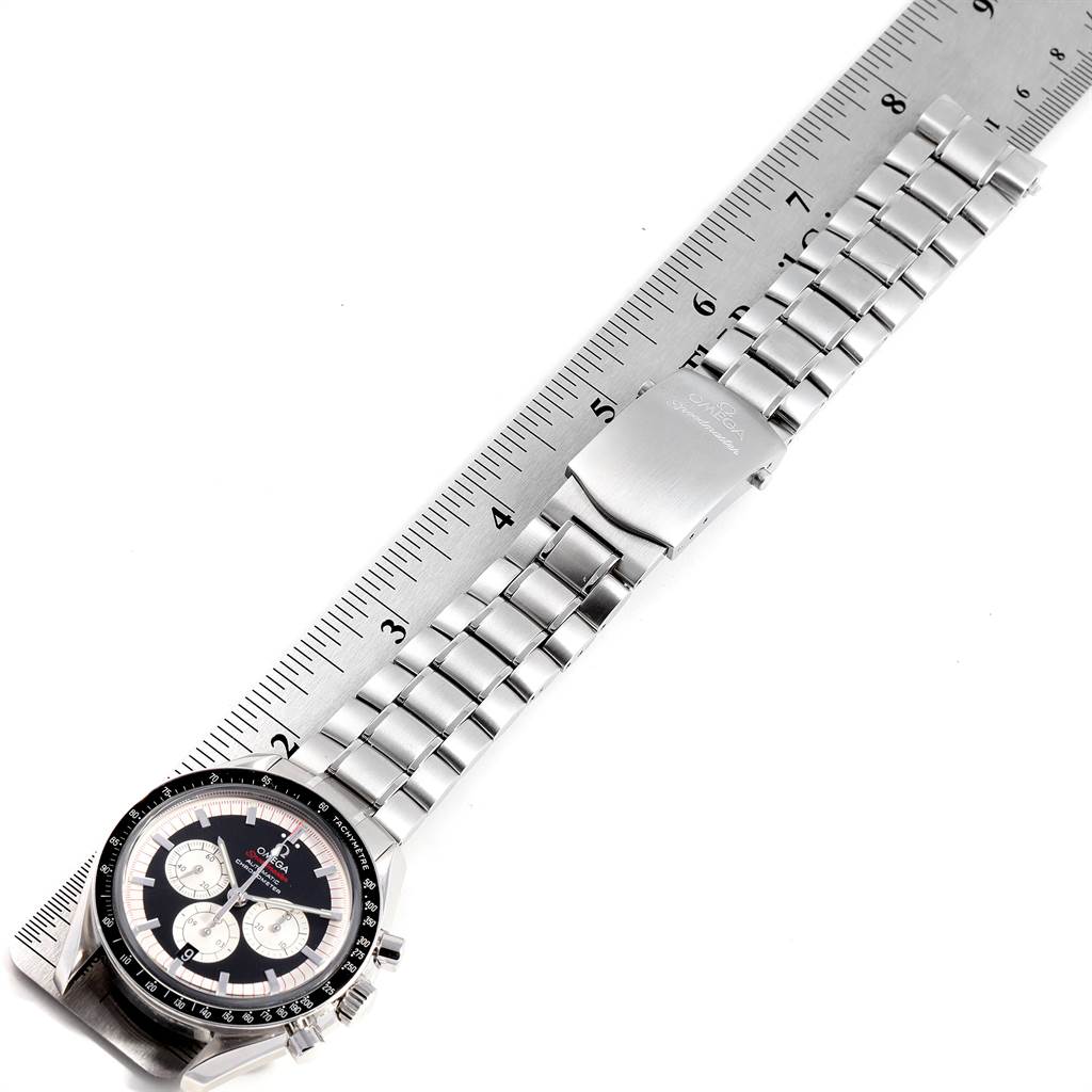 The image shows an Omega Speedmaster 3507.51.00 Men
s Stainless Steel Black Dial 3507.51.00 Men
s Stainless Steel Black Dial watch laid flat with a stainless steel bracelet alongside a measuring ruler, displaying the face and clasp.