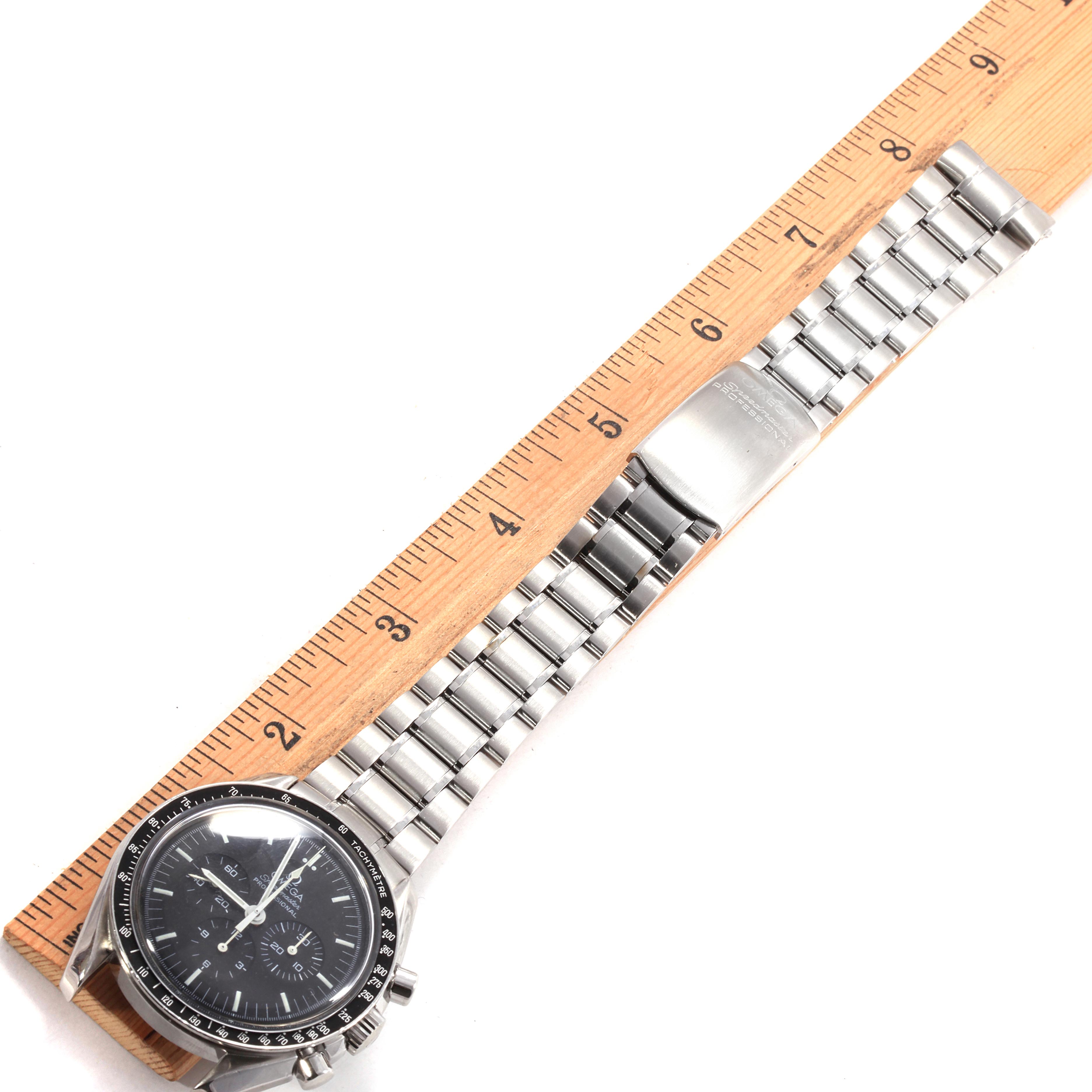 The Omega Speedmaster 3560.50.00 Men
s Stainless Steel Black Dial 3560.50.00 Men
s Stainless Steel Black Dial watch is shown from above, featuring the dial, bezel, and metal bracelet with a ruler for scale.