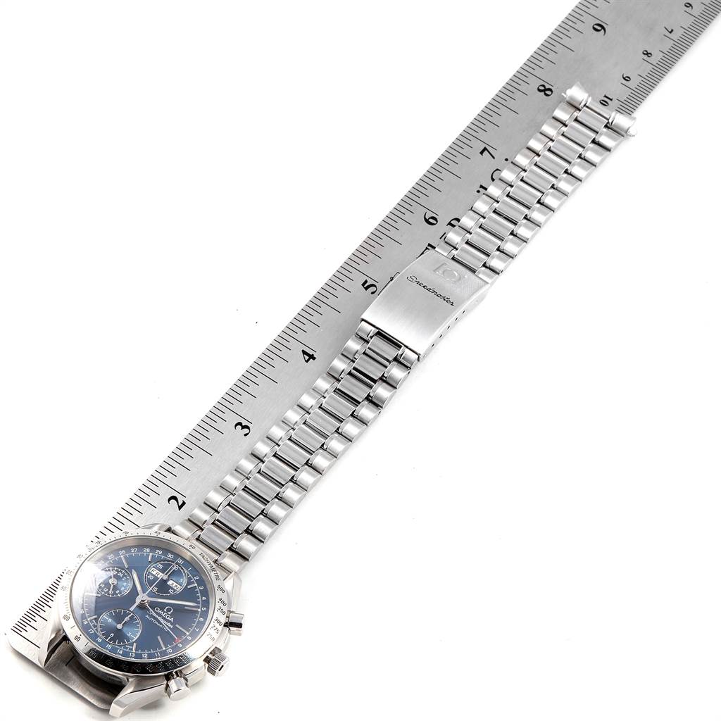 The Omega Speedmaster 3521.80.00 Men
s Stainless Steel Blue Dial 3521.80.00 Men
s Stainless Steel Blue Dial watch is shown flat with the face, bracelet, and clasp visible alongside a ruler for scale.