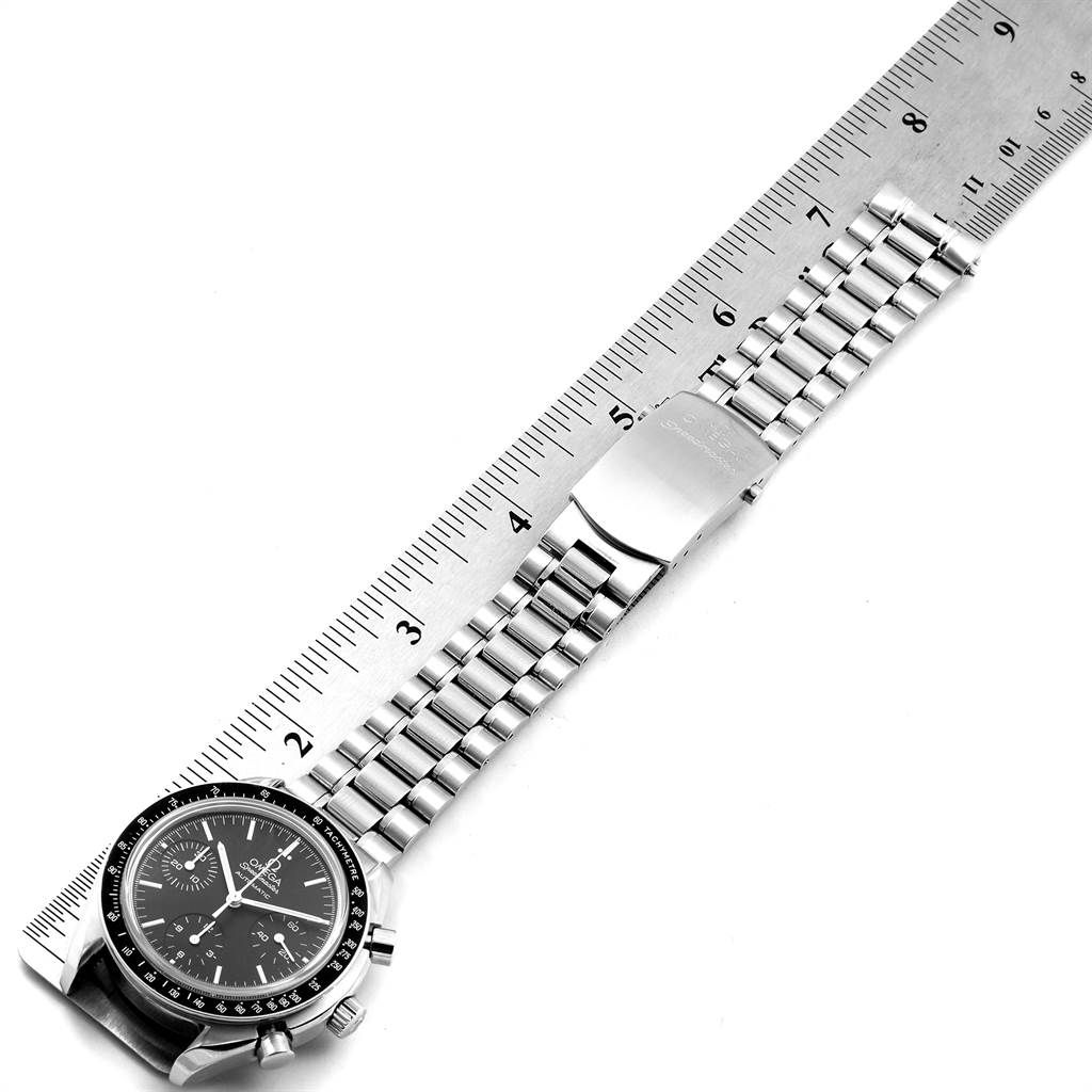 The image shows an Omega Speedmaster 3539.50.00 Men
s Stainless Steel Black Dial 3539.50.00 Men
s Stainless Steel Black Dial watch laid flat against a ruler, displaying its face, bracelet, and clasp.