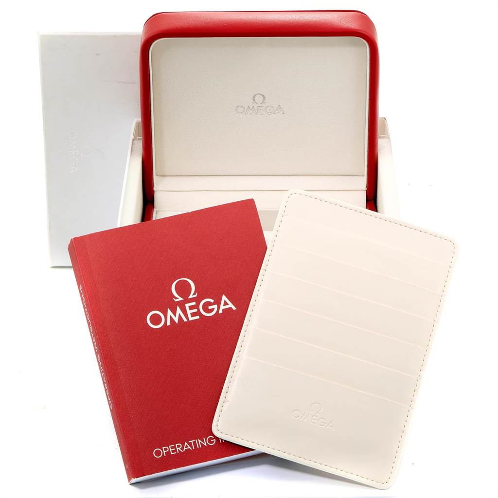 The image shows an Omega Speedmaster 321.13.44.50.02.001 Men
s Stainless Steel Silver Dial 321.13.44.50.02.001 Men
s Stainless Steel Silver Dial
s open red box, operating instructions booklet, and cardholder from a slightly elevated angle.