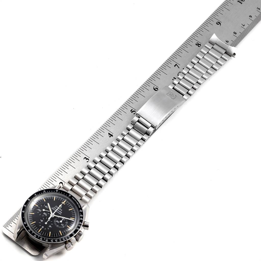 The Omega Speedmaster 145.022 Men
s Stainless Steel Black Dial 145.022 Men
s Stainless Steel Black Dial watch is shown flat with its stainless steel band extended and aligned with a ruler.