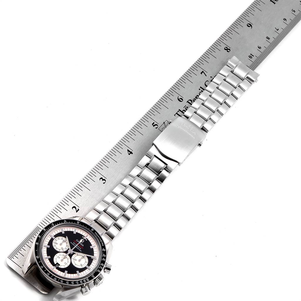 The image shows an Omega Speedmaster 3507.51.00 Men
s Stainless Steel Black Dial 3507.51.00 Men
s Stainless Steel Black Dial watch laid flat next to a ruler, displaying the bracelet and clasp.