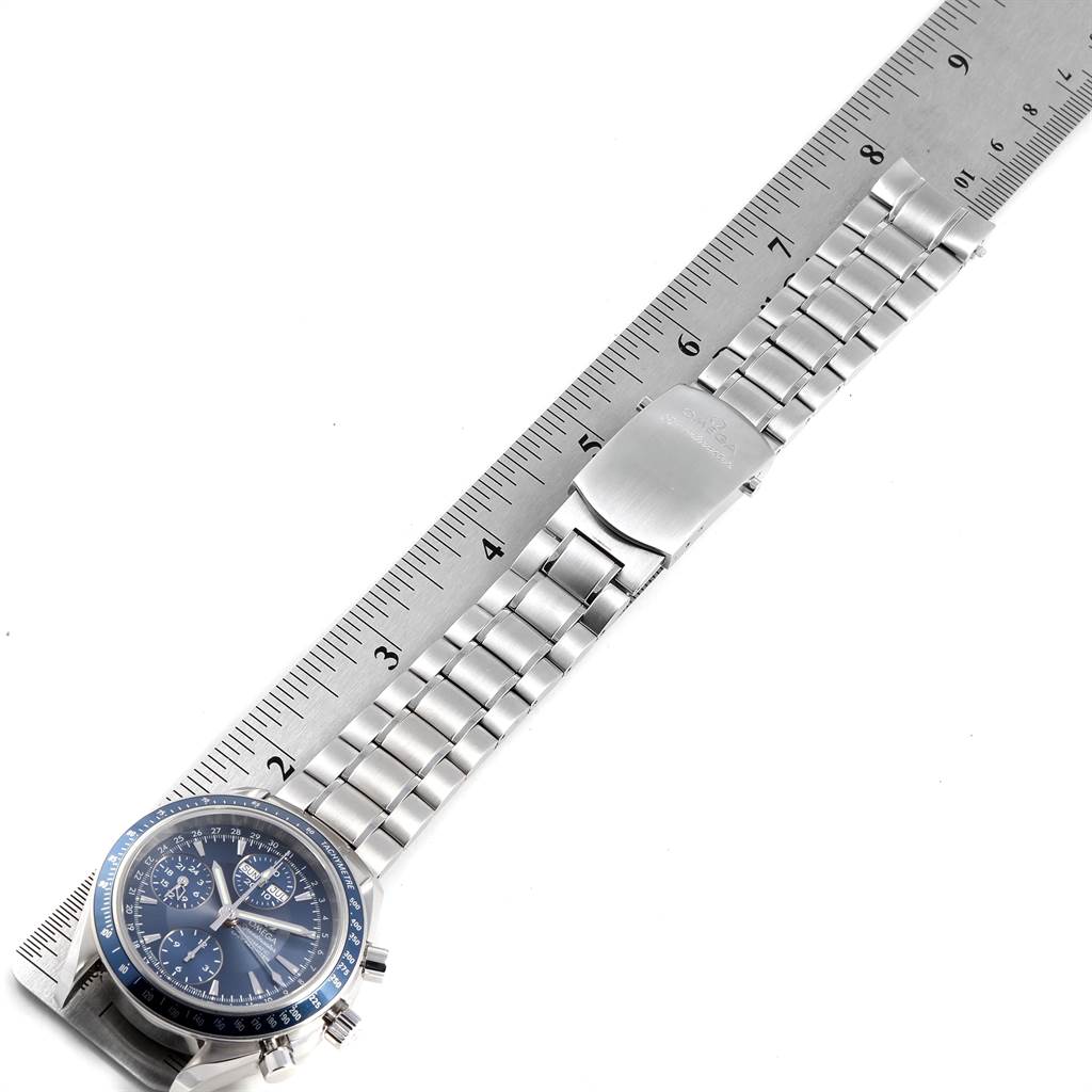 The image shows an Omega Speedmaster 3222.80.00 Men
s Stainless Steel Blue Dial 3222.80.00 Men
s Stainless Steel Blue Dial watch laid flat with the face, band, and clasp visible against a ruler for measurement.