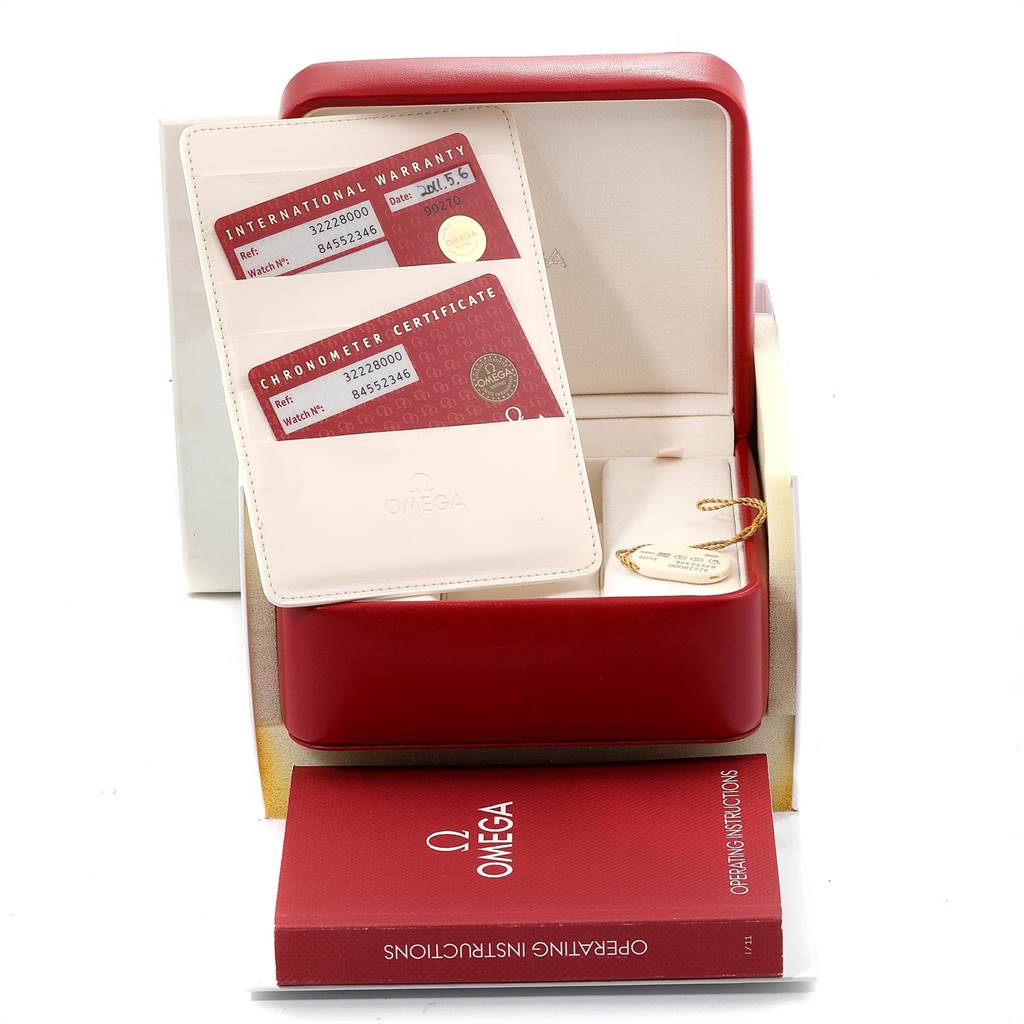 The image shows an Omega Speedmaster 3222.80.00 Men
s Stainless Steel Blue Dial 3222.80.00 Men
s Stainless Steel Blue Dial box with international warranty cards, a chronometer certificate, and an operating instructions booklet.