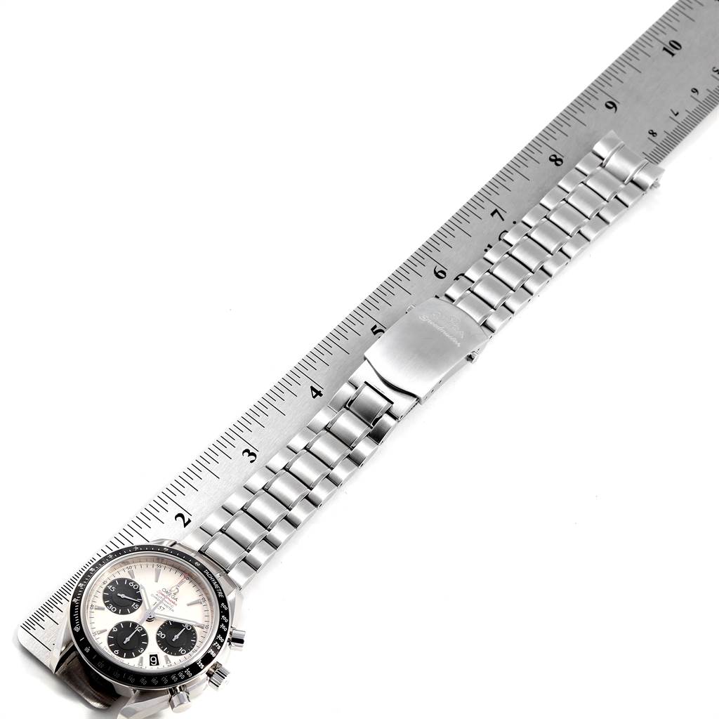 The image shows an Omega Speedmaster 323.30.40.40.02.001 Men
s Stainless Steel White Dial 323.30.40.40.02.001 Men
s Stainless Steel White Dial watch laid flat with its bracelet and clasp fully extended, next to a ruler.