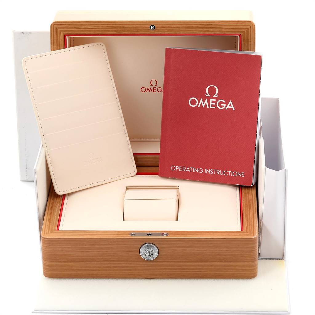 This image shows the packaging of an Omega Speedmaster 331.20.42.51.01.002 Men's Steel and Gold (two tone) Black Dial 331.20.42.51.01.002 Men's Steel and Gold (two tone) Black Dial, featuring the box, operating instructions, and cardholder.